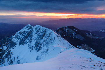 Stunning winter evening mountains landscape and the citylights in the valley, Brasov