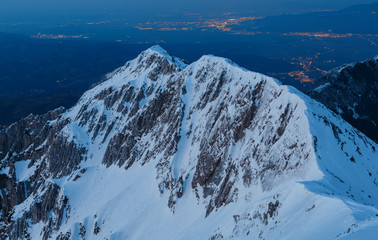 Stunning winter evening mountains landscape and the citylights in the valley, Brasov