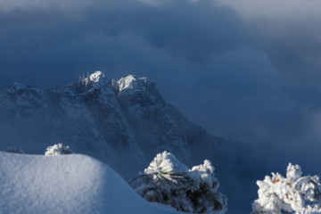 Amazing landscape of rugged mountain ridge raising above the clouds and fog