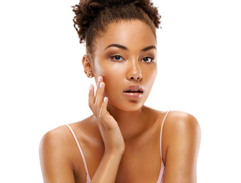 Attractive girl with perfect skin, touching her face. Photo of african girl on white background. Beauty & Skin care concept