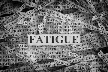 Torn pieces of paper with the word Fatigue