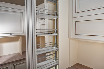 Close Up home interior. Kitchen - opened door with chrome furniture shelf. Wood and Chrome Material, Modern Design.