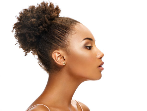 Young african girl in profile on white background. Youth and skin care concept