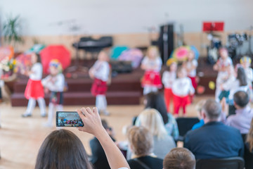 Children's holiday in kindergarten. Children on stage perform in front of parents. image of blur kid 's show on stage at school , for background usage. Blurry
