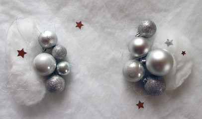 Christmas balls with stars on snowy background