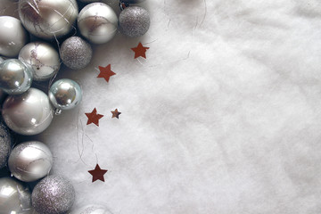 Christmas balls with stars on snowy background