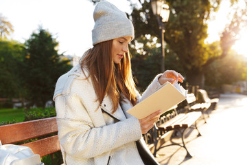 Beautiful young woman dressed in autumn coat and hat