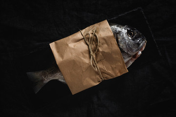 Raw  Golden fish in paper