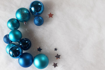Silver and blue christmas balls on white snowy background