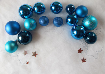 Silver and blue christmas balls on white snowy background