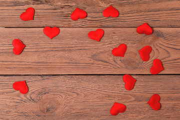 Valentine day wood background with hearts, top view