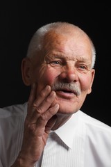 Joyful senior on a black background
