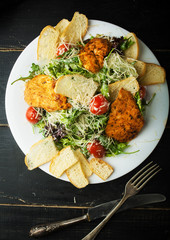 Delicious chicken Caesar salad on a plate