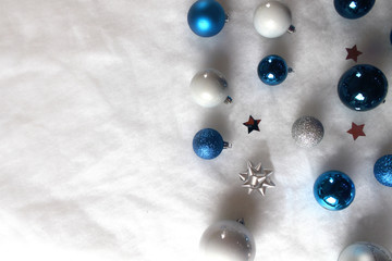 Silver and blue christmas balls on white snowy background