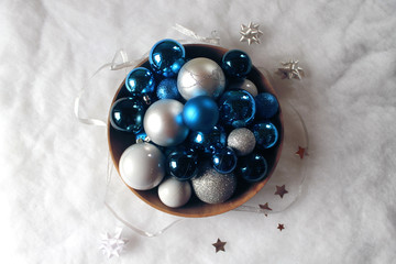 Silver and blue christmas balls in a bowl