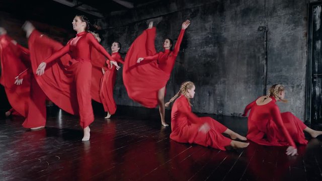Well-coordinated dance group performs a beautiful show. The dance is gentle and emotional.