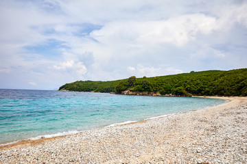 Sailing yacht in the Mediterranean. Concept of travel and active lifestyle. Stone beach and warm sea