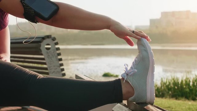 Woman stretching her legs before jogging