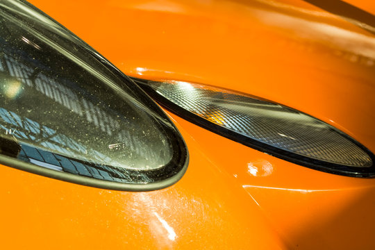 Sports car headlights. Orange Lotus.