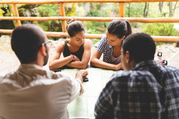 Group of hikers sitting together planning a hiking route looking at map