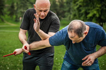 Knife vs knife. Kapap instructor demonstrates fighting and disarming technique