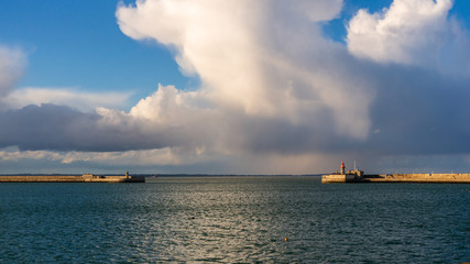 Dun Laoghaire pier lighthouses under a dramatic sky before the storm. Seascape in County Dublin, Ireland.