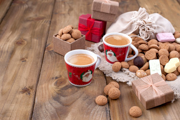 St. Nicolas day concept. Dutch holiday Sinterklaas, festive breakfast with coffee, kruidnoten, traditional sweets and presents. Top view. Free space for text.