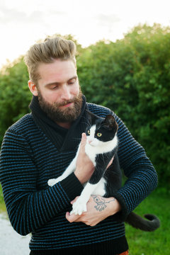 Young man holding a cat in Sweden