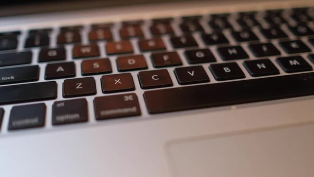 Close-up and defocus of laptop keyboard with focus buttons key. Royalty high-quality stock video footage of blur laptop keyboard buttons. blurry background and focus computer keyboard
