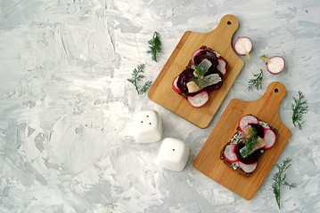 Smorrebrod, a traditional Danish open sandwich on dark rye bread with herring, pickled beets and...