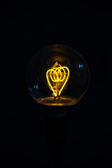 Illuminated light bulb on black background
