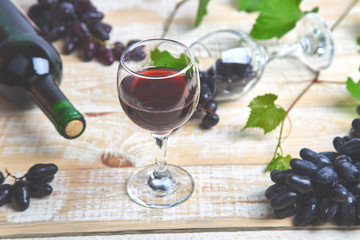 Red wine concept with bottle, glass and grapes