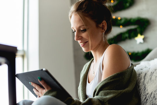 Smiling woman with digital tablet