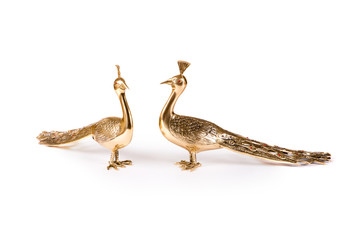 Vintage metal bird figurines on white background
