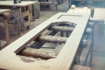 Wooden door in production in the shop. Factory doors.