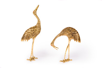 Vintage metal bird figurines on white background
