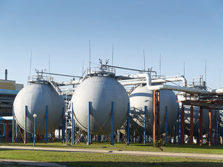 Industrial landscape with view of several ball gasholders with lightning protection and safety...