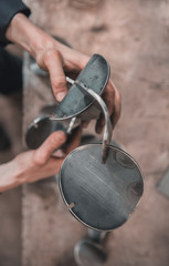 Industrial laser cut steel metal pieces in a cold hard industrial factory setting. Metal iron cut pieces being prepared for manufacture.