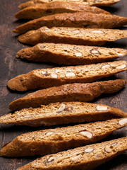 Close View Of Biscotti - Traditional Italian Almond Dessert On Dark Background. Cookies Arranged On The Center In Photo. Selective Focus,  Vertical Composition.