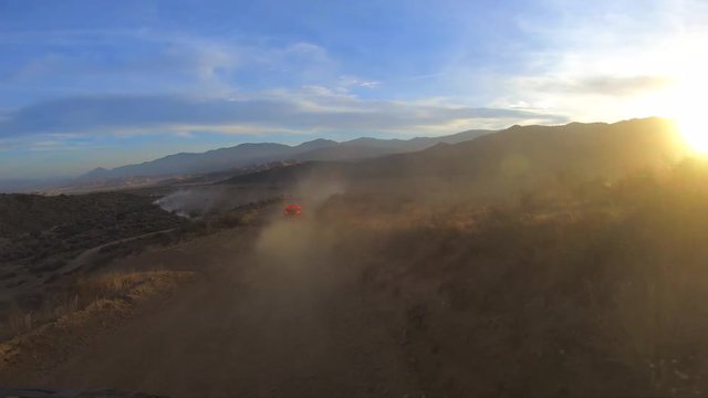 POV fast trail running in dusty California desert at golden hour