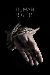 man tied up and text human rights