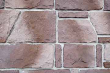 Stone for exterior decoration of the facade of the building.  The texture of the wall of artificial stone. Building stone for exterior decoration.