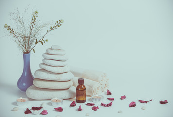 Spa still life with towels, stones, bath oil and candle