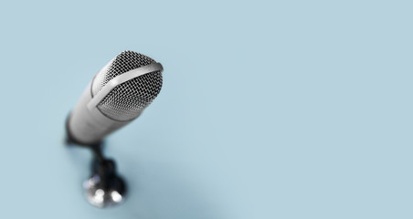 technology and audio equipment concept - close up of microphone at recording studio or radio...