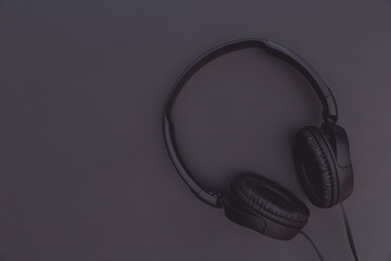 Black music headphones on dark background copy space