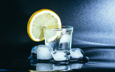 Glass of gin, ice and lemon