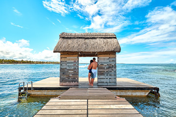 man and woman tourist on jetty in mauritius island, belle mare beach