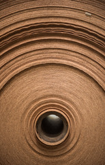 A beautiful smooth clean paper roll machine creating a continuous sheet of brown freshly made paper...