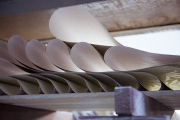 A beautiful smooth clean paper roll machine creating a continuous sheet of white freshly made paper...
