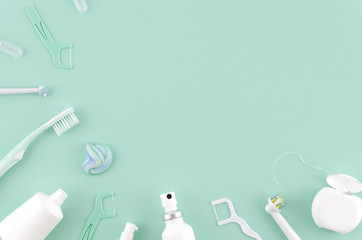 Flat lay composition with manual toothbrushes and oral hygiene products on mint background Stomatologist mock up copy space. Teeth care Frame concept - obrazy, fototapety, plakaty